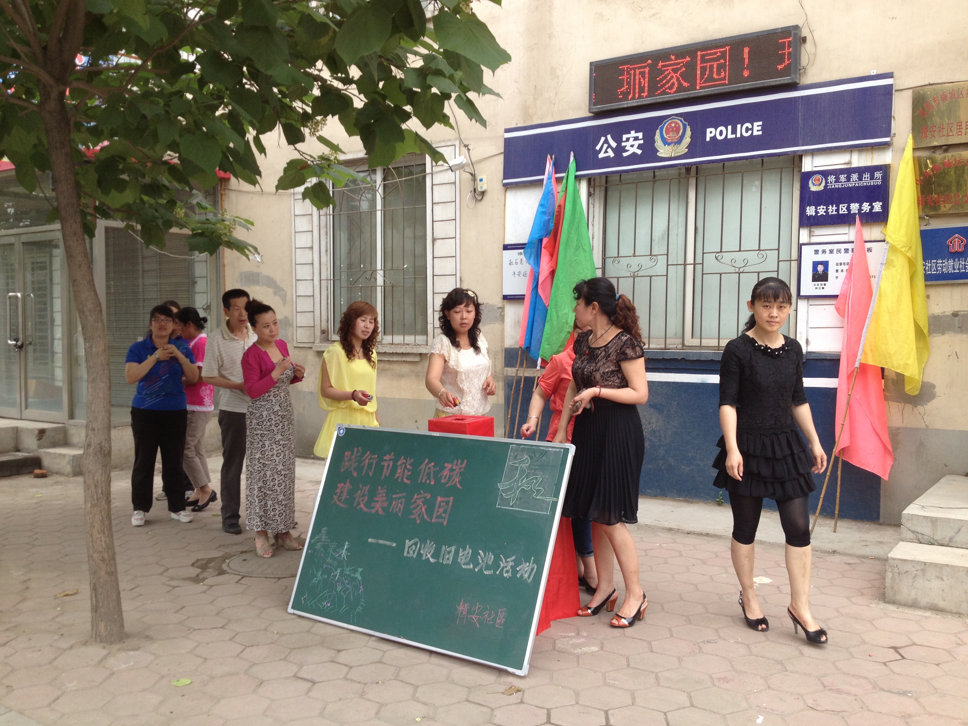 在社区门前居民进行低碳环保宣传